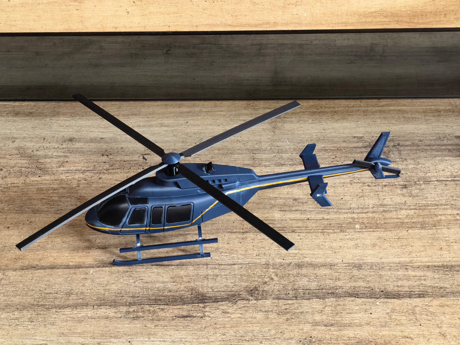 Real helicopter prototype photographed from above, showing the rotor, painted fuselage and tail