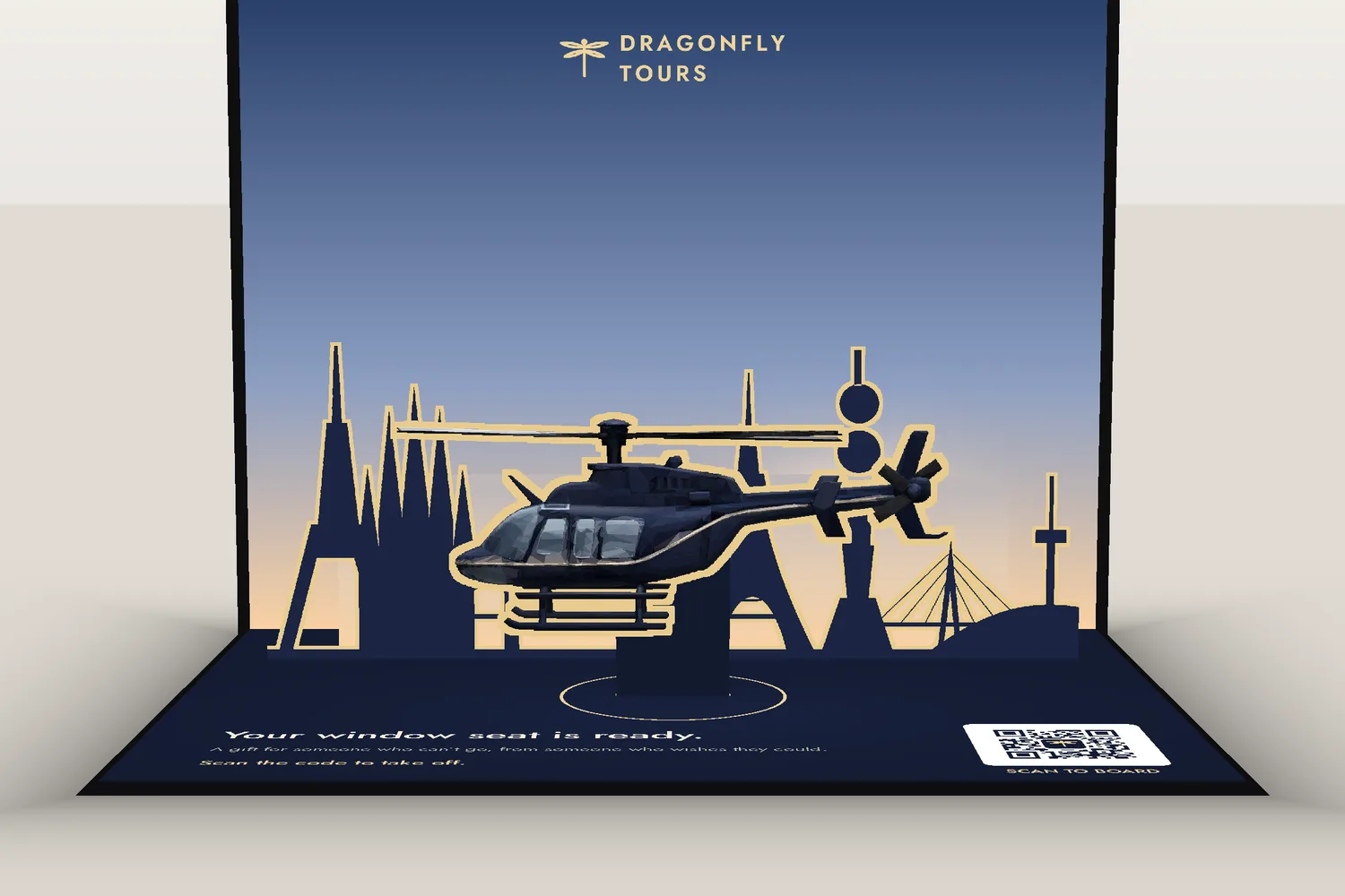 Design rendering of an open Dragonfly Tours pop-up card, with a helicopter, skyline and QR code